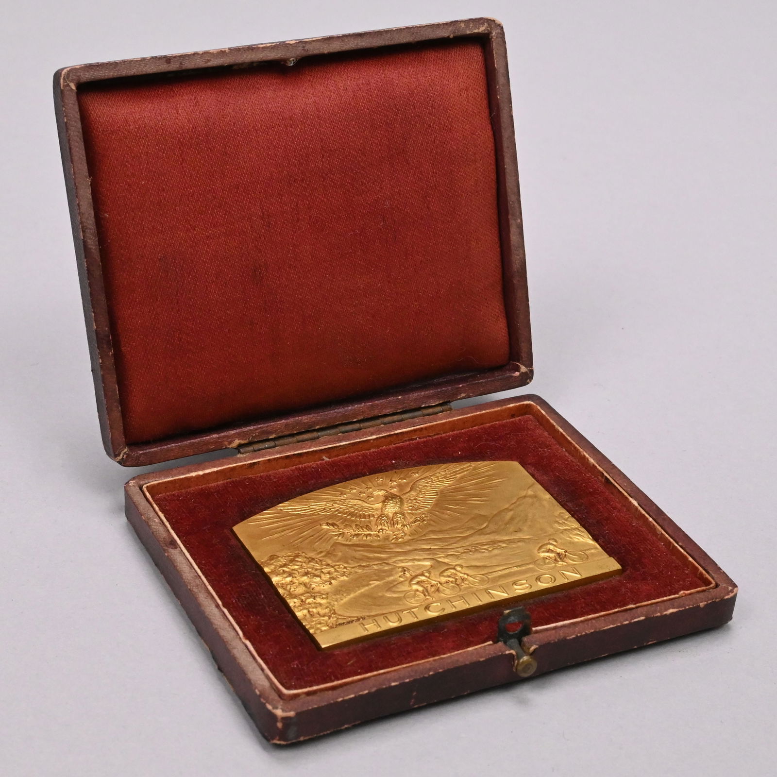 Rene Brangier- Gilt-Bronze Medal, Hutchinson Tire: Rene Brangier. French Gilt-Bronze Medal for the Hutchinson Tire Company. Cast on the obverse with an eagle grasping laurel branches and enclosing ten stars within its wings, in the sky above four