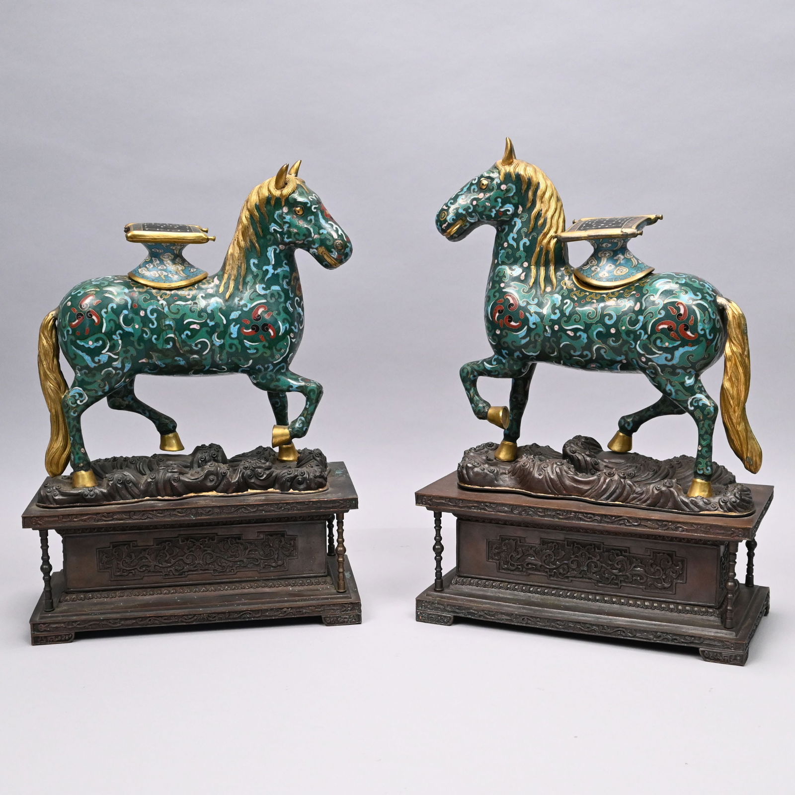 Pair of Chinese Cloisonne Figural Censers: Pair of Chinese Cloisonne Figural Censers, 20th Century. Each pawing horse decorated with blue, green, red, black and white scrolls and geometric shapes on a green ground, gilt-edged aperture and