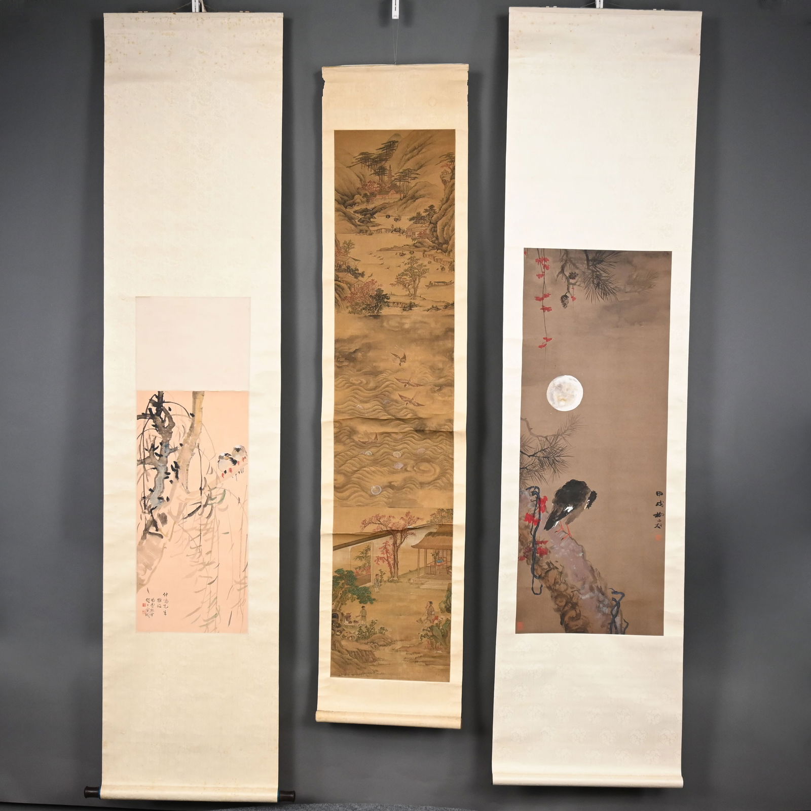Three Chinese Hanging Scroll Paintings: Three Chinese Hanging Scroll Paintings. Comprising a bird perched on flowering branches under the moon, image 42.75 x 16.5 in., scroll approximately 84 x 21.25 inches; two birds amid bamboo and