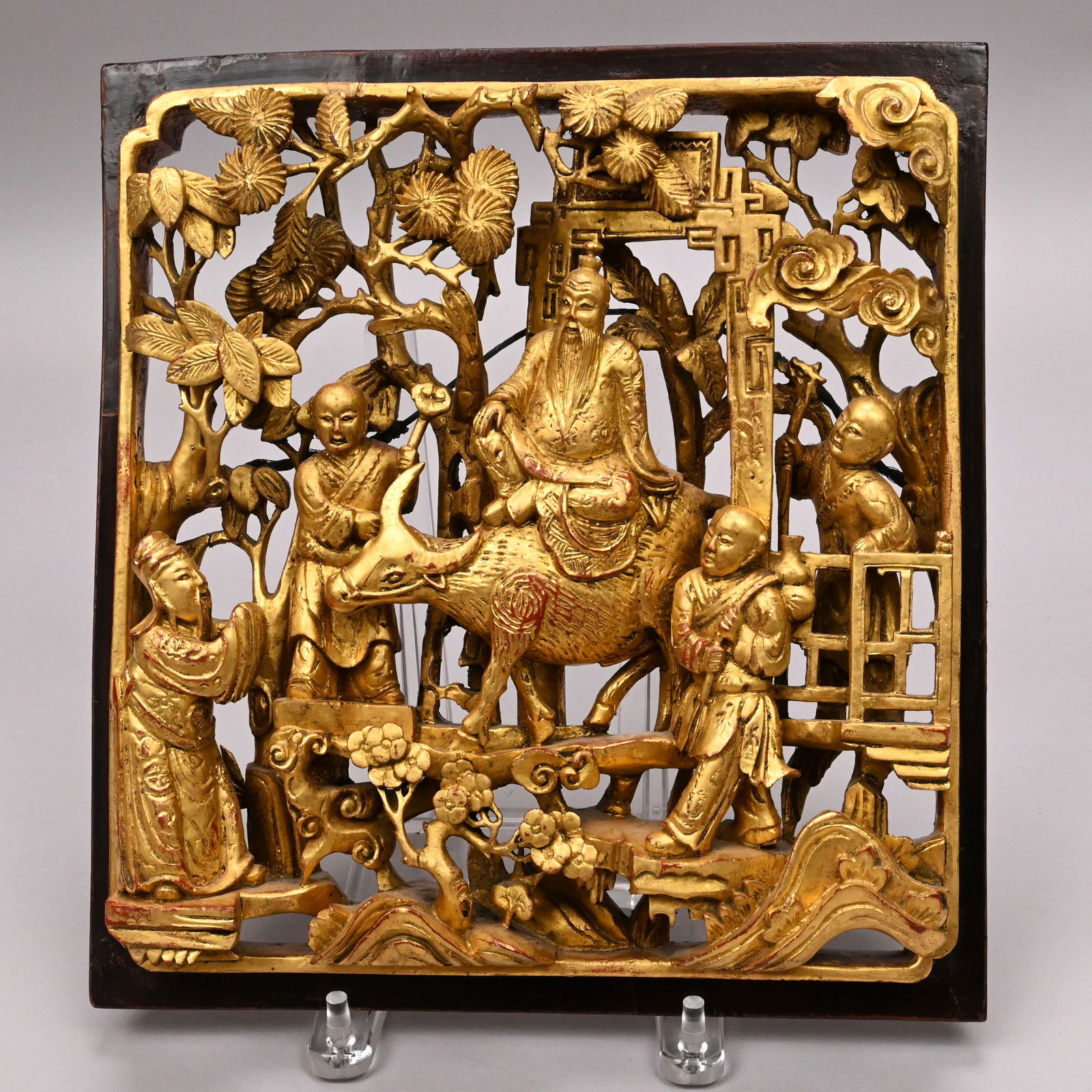 Chinese Carved Giltwood Narrative Wall Plaque: Chinese Carved Giltwood Narrative Wall Plaque, 19th Century. Carved in high relief with the figure of Laozi astride his water buffalo, exiting China through a gateway before Buddha standing with
