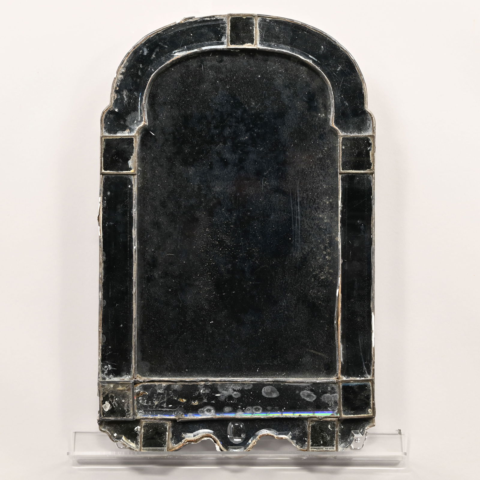 French Looking Glass: French Looking Glass, Luneville, 19th Century. The rectangular bevelled mirror plate with arched crest within a panelled surround, indecipherable inscription on the reverse, possibly a town name.H: