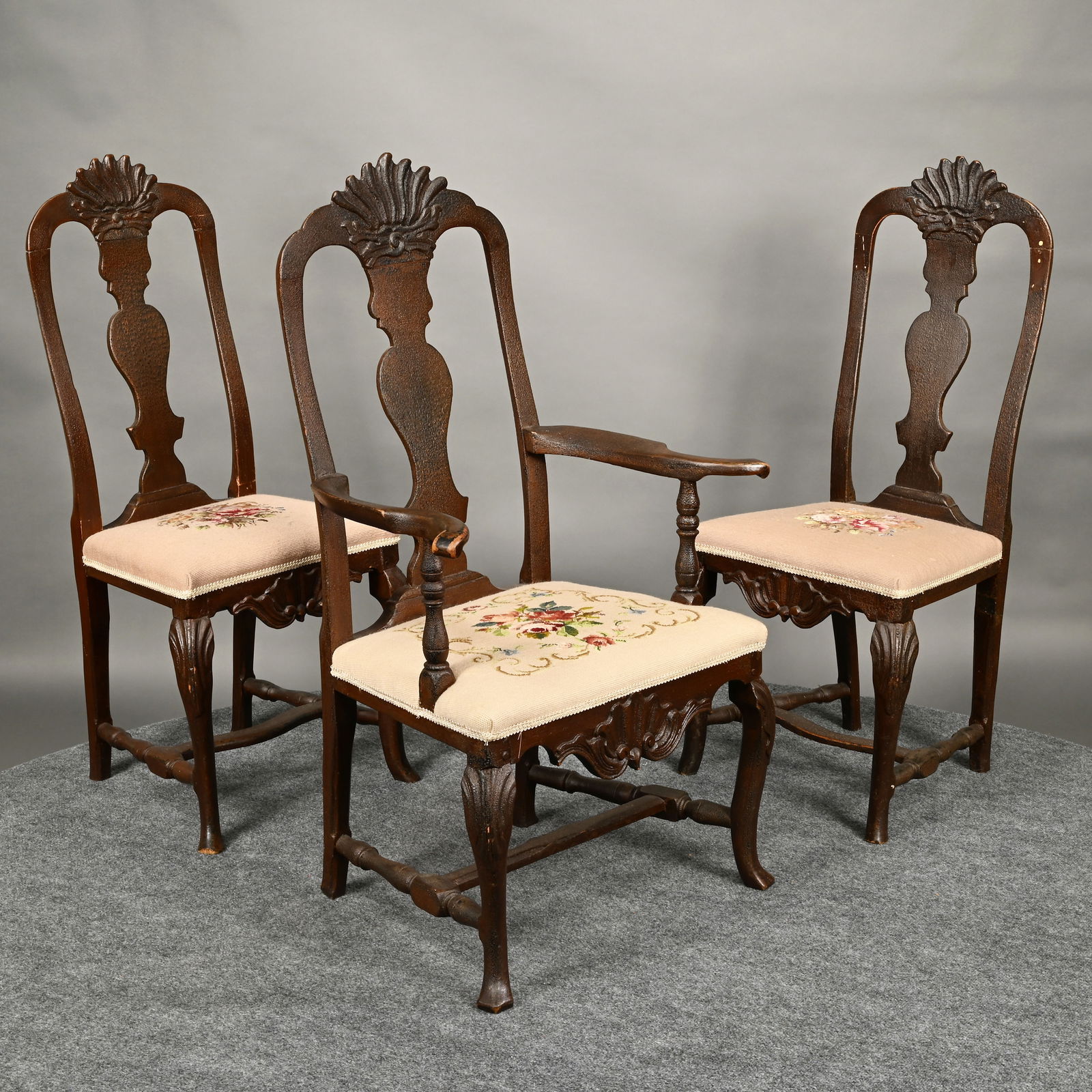 Set of Three Continental Baroque Dining Chairs: Set of Three 18th Century Continental Baroque Dining Chairs, probably Norwegian. The crest rail with dramatic shell carving above a vasiform splat, the armchair with outward-swept arms and handholds,