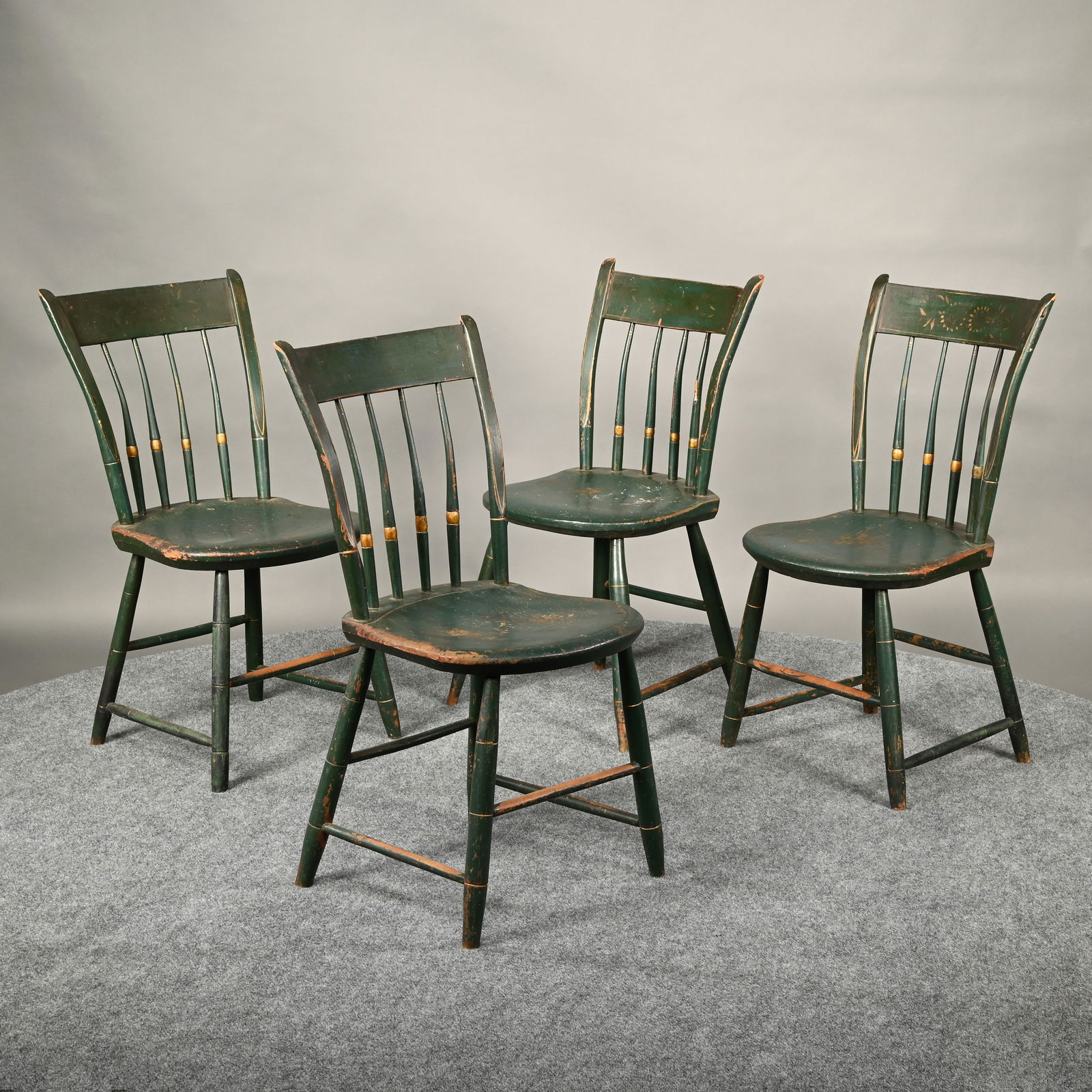 Set of Four New England Windsor Dining Chairs: Set of Four New England Thumb-Back Windsor Dining Chairs, Early 19th Century. In green paint with gilt banding and borders, the slat crest above four spindles and a plank seat, one slat painted with