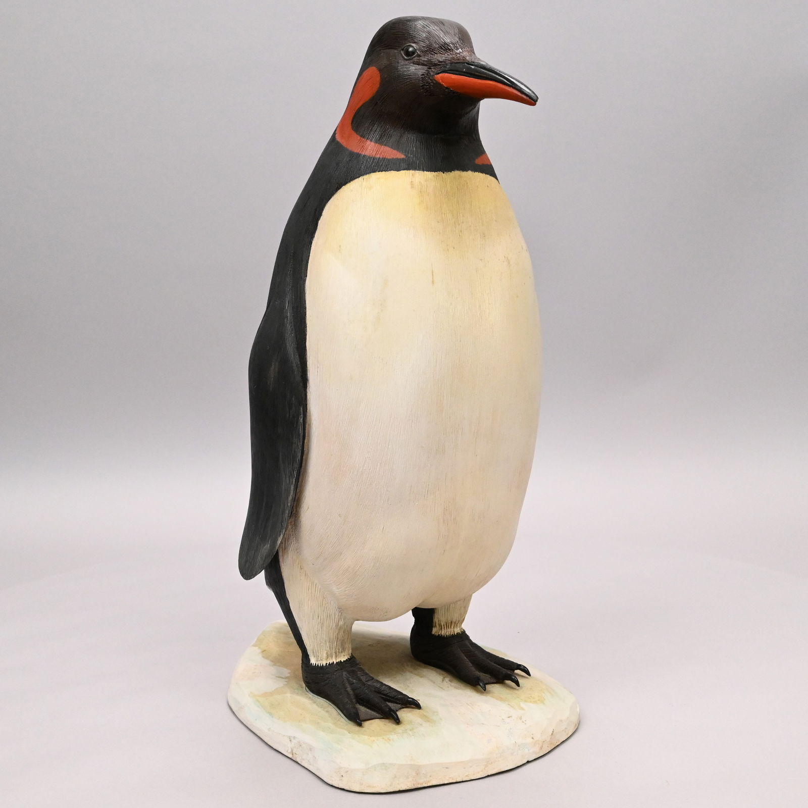 Folk Art Carved & Painted Figure of Penguin,Signed: Folk Art Carved and Painted Wood Figure of a Penguin, Signed, 20th Century. In black and white paint with red cheek patches and bottom beak, glass eyes, standing on a mound of snow, signed "F (?)