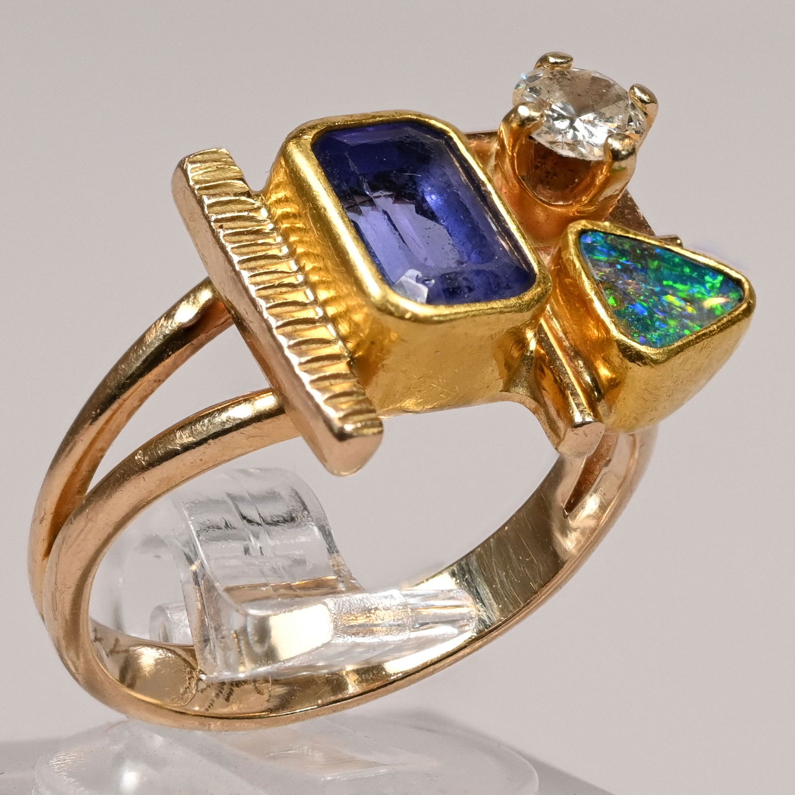 Ladies 22k Gold, Diamond, Tanzanite & Opal Ring: Ladies Modernist 22k Gold, Diamond, Tanzanite and Opal Ring. Cushion-cut tanzanite and 0.25 carat diamond, marked "22kt." and signed indistinctly, possibly "KIM" or "KJM."5.2gSize 6-1/4