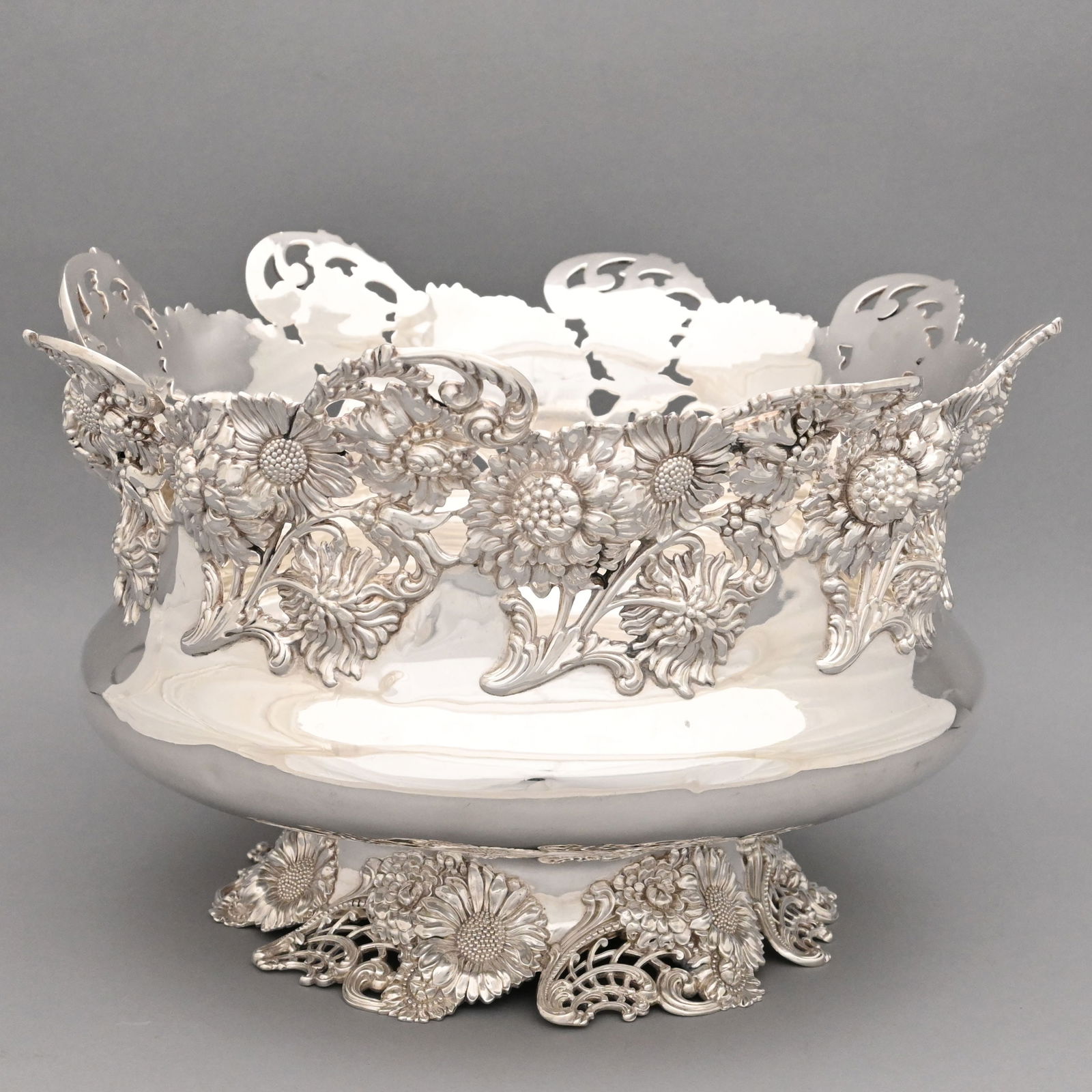 American Sterling Silver Center Bowl: American Sterling Silver Center Bowl, Dominick & Haff, New York, New York, 1869. The outset circular sides beneath cast and pierced chrysanthemums, daisies and curled stems, the matching foot pierced