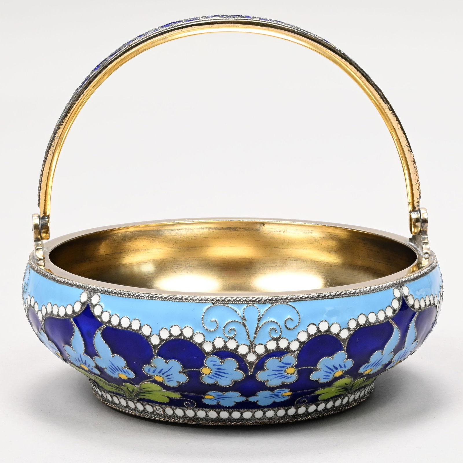 Russian Silver-Gilt and Enamel Sugar Bowl, Moscow: Russian Silver-Gilt and Cloisonne Enamel Sugar Bowl, Cyrillic Initials A*T., Moscow, Late 19th-Early 20th Century. The sides surrounded by flowering plants in green and light blue enamels, reserved