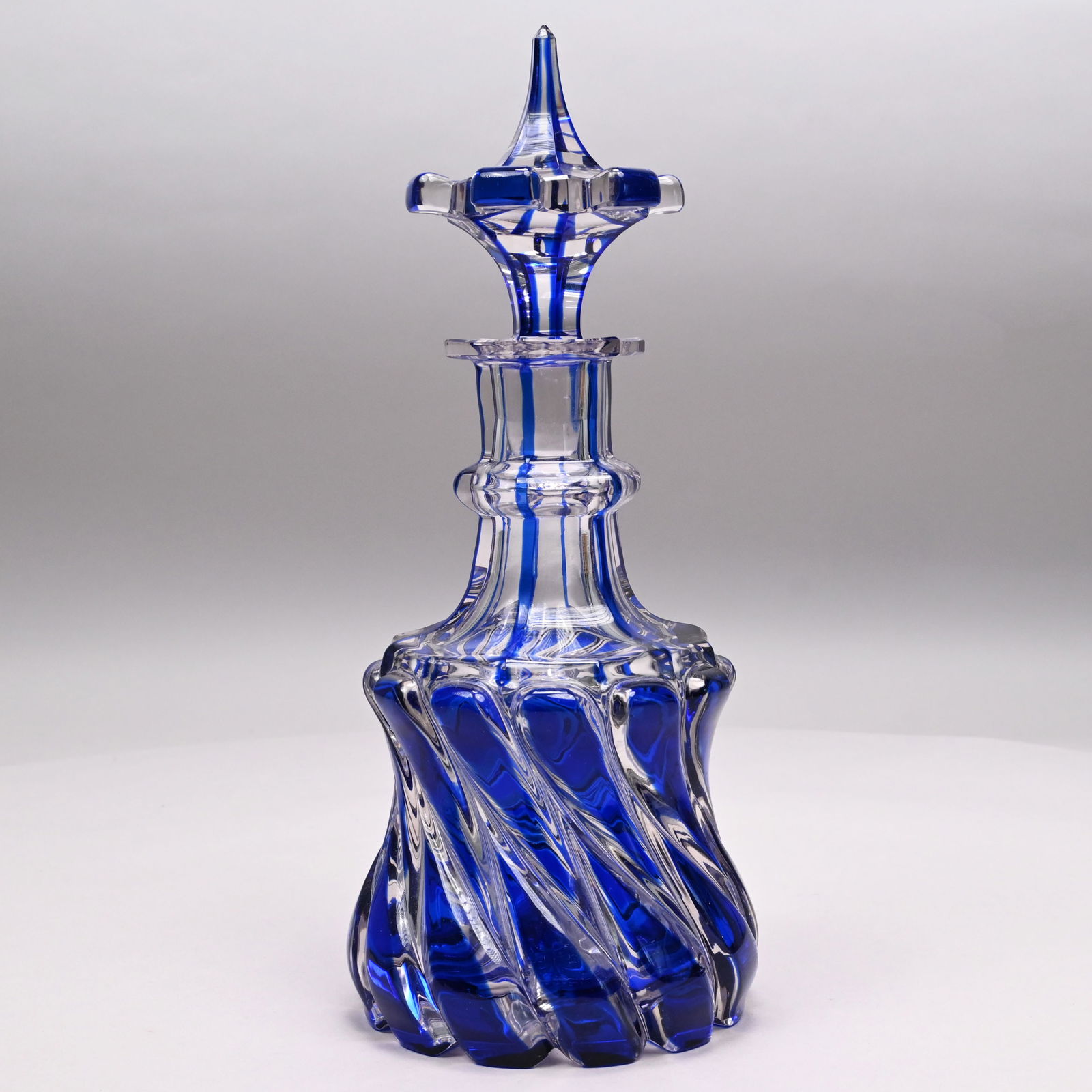 Russian Cobalt Blue to Colorless Glass Decanter: Russian Cobalt Blue to Colorless Glass Decanter and Stopper, Attributed to the Imperial Glass Factory, Saint Petersburg, Late Eighteenth - Early Nineteenth Century. The waisted spiral decanter in