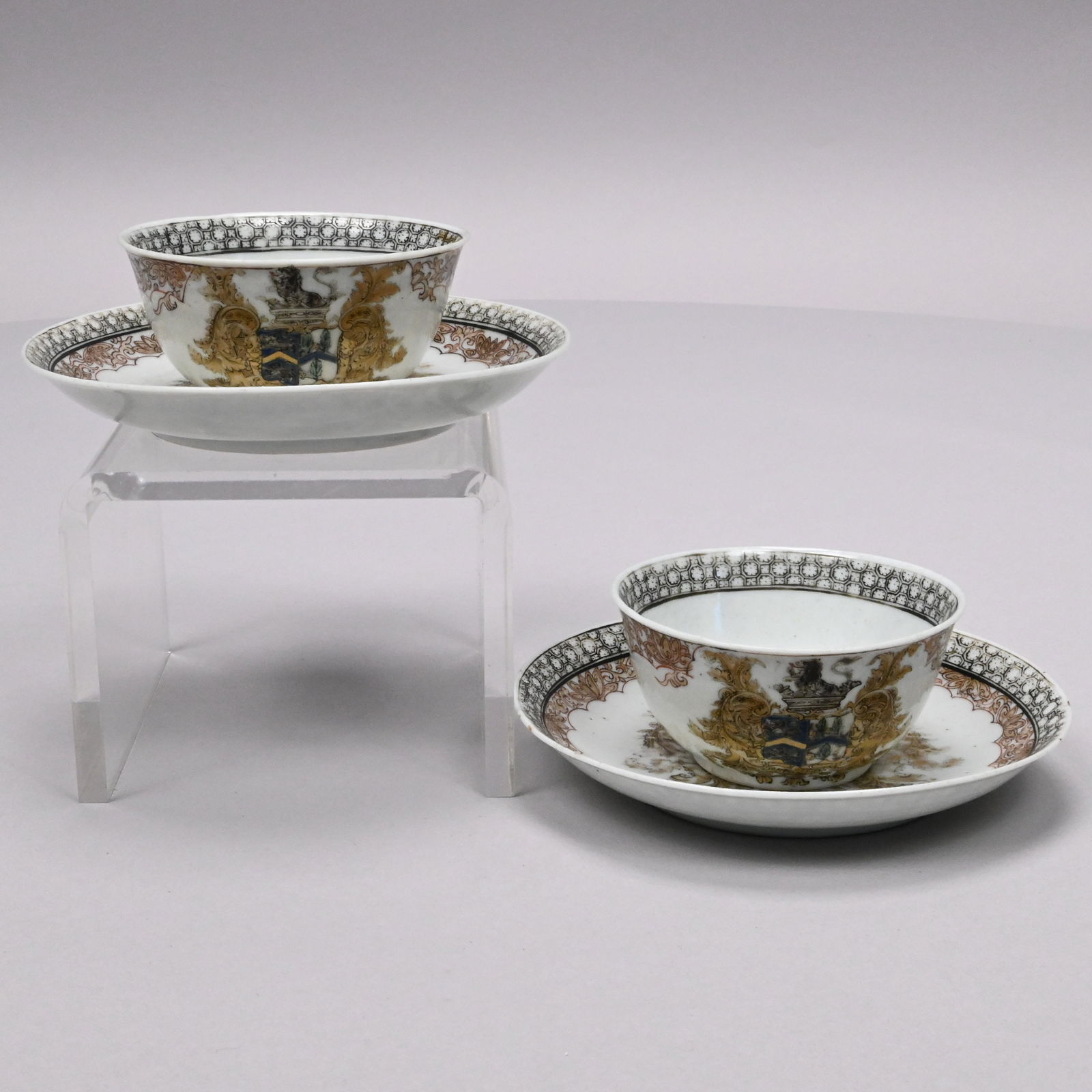Pair Chinese Export Armorial Teabowls & Saucers: Pair of Chinese Export Porcelain Armorial Teabowls and Saucers, 1735-1750. Probably Continental coat-of-arms, possibly Dutch, painted en grisaille and gilt with the crest and coat-of-arms, within
