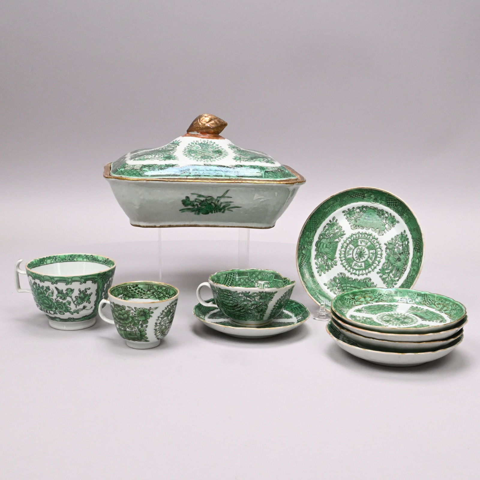 Chinese Export Porc Green Fitzhugh Tureen & Others: Chinese Export Porcelain Green Fitzhugh Vegetable Tureen and Cover, a Plate and Group of Cups and Saucers, 1800-1860. The tureen with gilt rim and pinecone knop; the remaining comprising a 6-inch