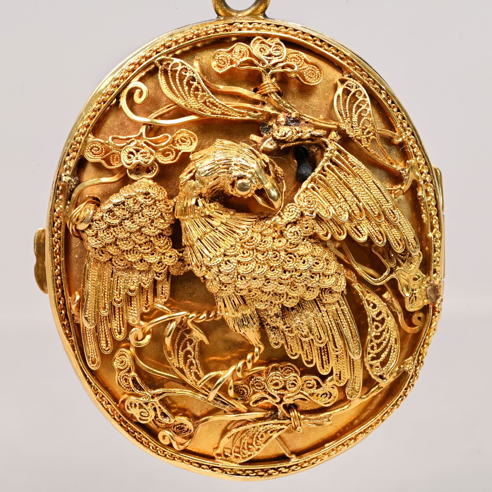Rare Chinese Export 18k Gold Filigree Locket: Rare Chinese Export for the American Market 18k Gold Filigree Locket with 14k Gold Chain, Possibly Cum Wo, Hong Kong, 1880s. Oval, the front cover applied with a shield engraved with the letter "W,"