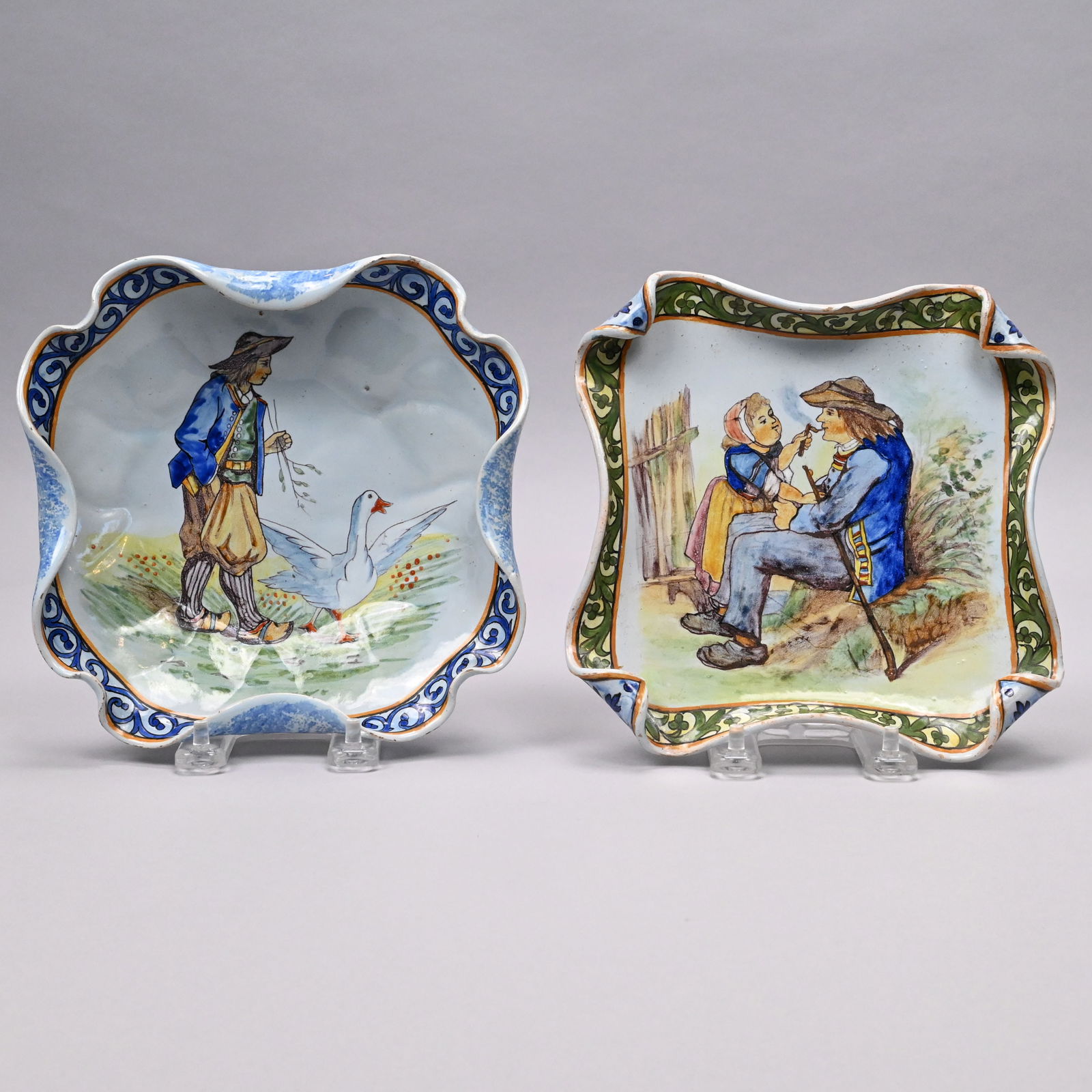 Two Quimper Faience Coupes, Porquier Factory: Two Quimper Faience Curled-Edge Coupes, Porquier Factory, 1875-1903. The first painted with a view of a farmer strolling along with his goose, painted with the first mark of a trefoil "PB" for the