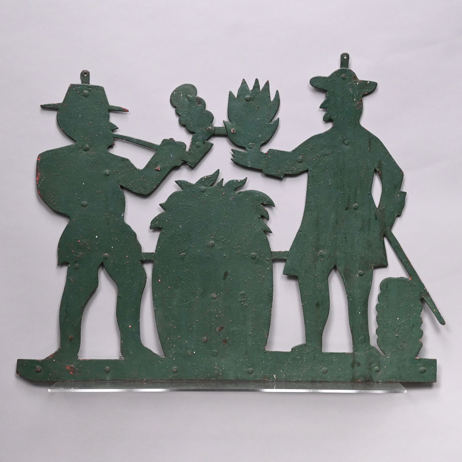 Folk Art Sheet Metal Weathervane in Green Paint: Folk Art Sheet Metal Weathervane in Green Paint. Cut out in the shape of a planter offering a sheaf of tobacco to a man smoking a pipe, each centering a barrel full of tobacco leaves.H: 22.875 in.