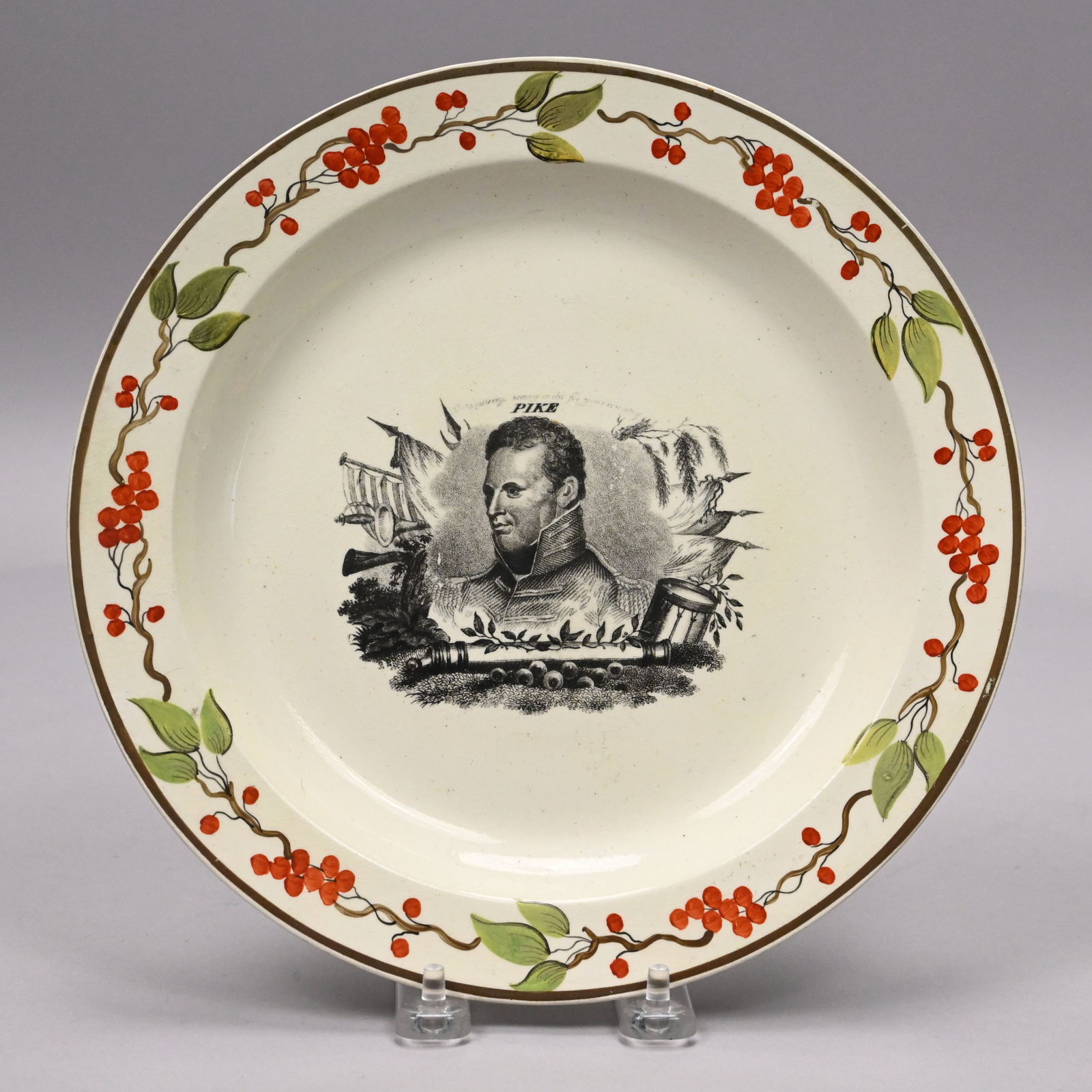 "Pike," English Creamware Printed & Enameled Plate: "Pike," English Creamware Black Transfer-Printed and Enamel-Decorated Plate, After 1812. Printed with a portrait of Brigadier General Zebulon Montgomery Pike (1779-1813), beneath the motto "Be always