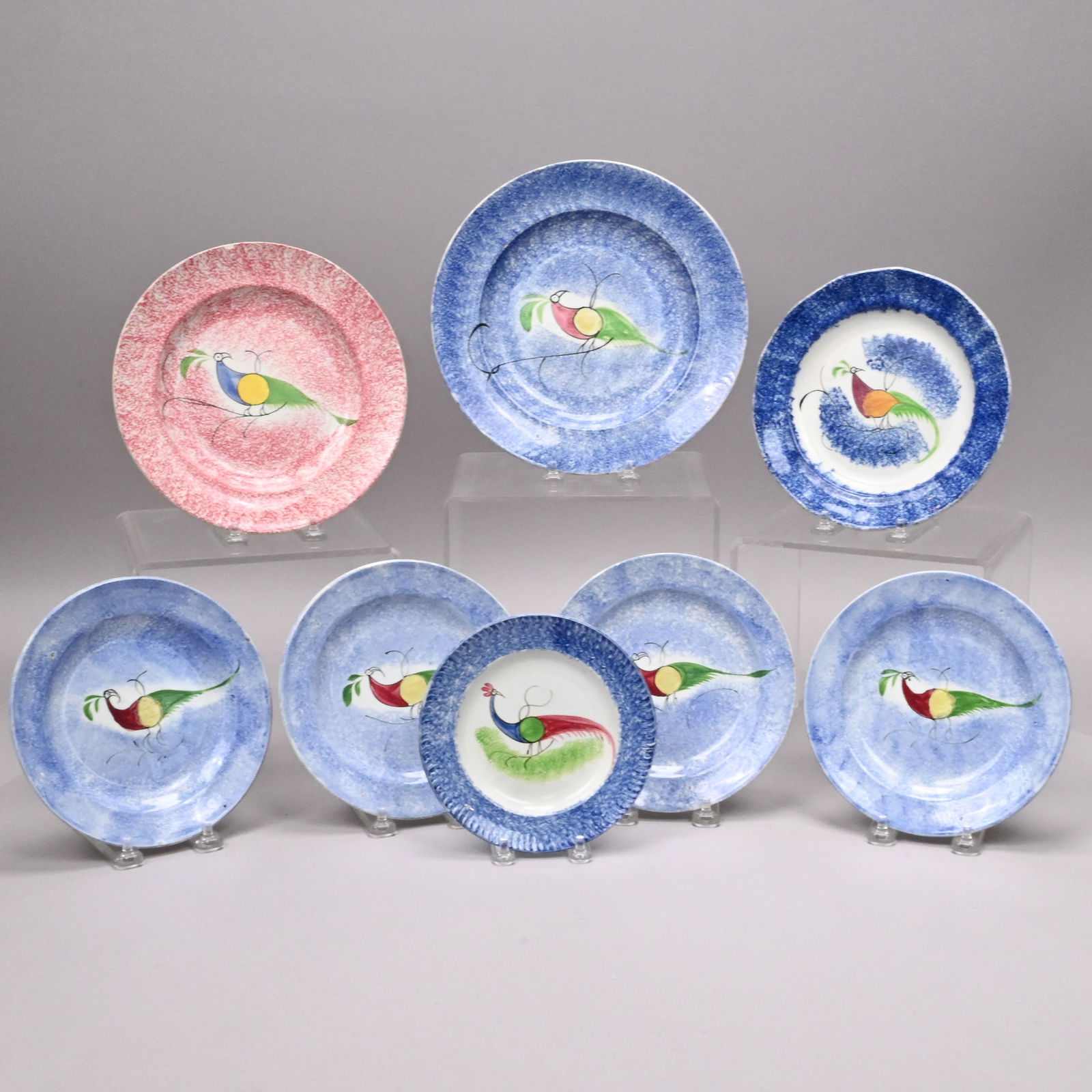 Eight British Spatterware 'Peafowl' Plates: Eight British Spatterware 'Peafowl' Plates, 1825-1850. The peafowl painted in various combinations of red, blue, green, yellow and ochre enamels, comprising a set of four blue sponged 7.125-inch