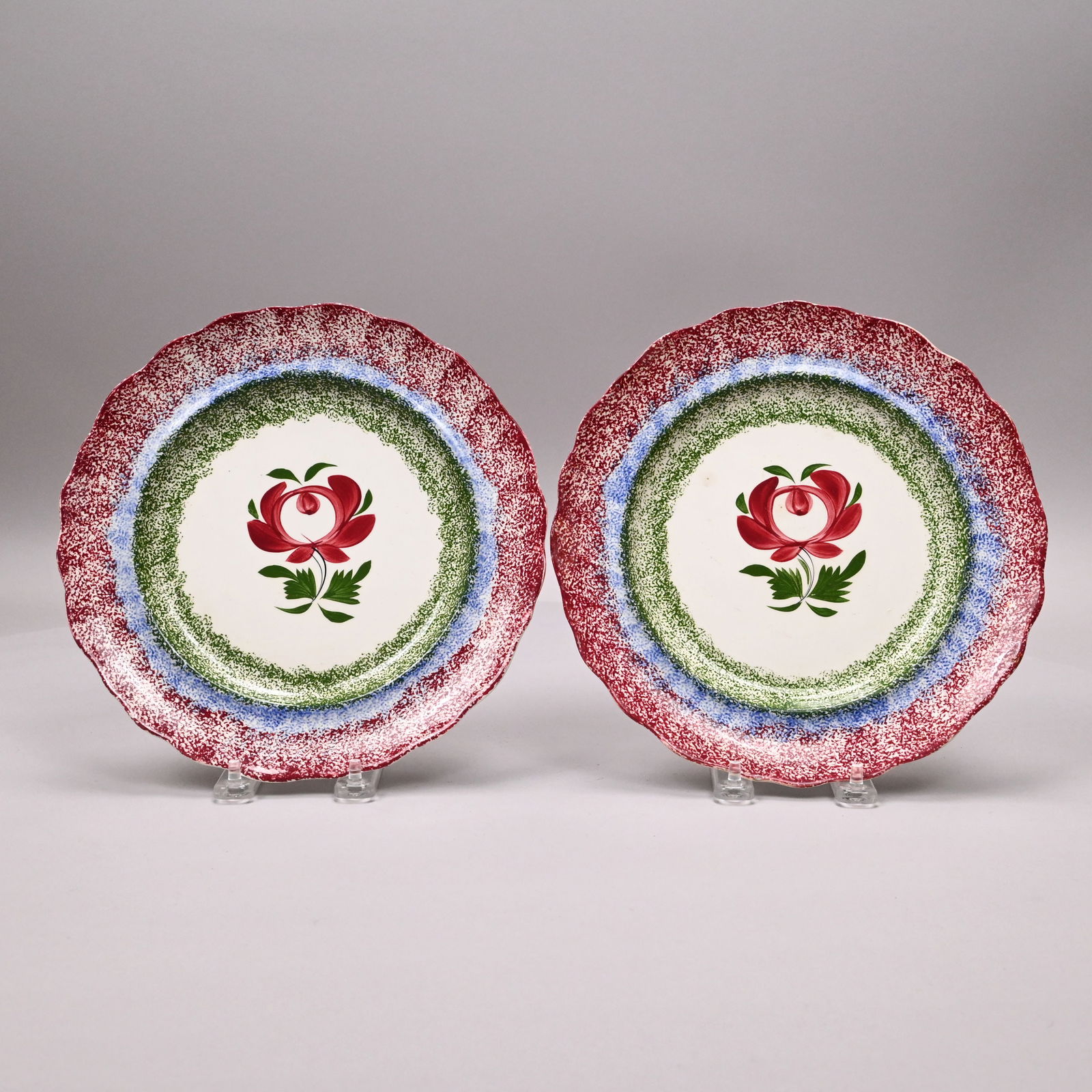 Pr Staffordshire Spatterware 'Adam's Rose' Plates: Pair of Staffordshire Rainbow Spatterware and Painted 'Adam's Rose' Plates, 1830-1840. Each painted in the center with a rose stem in red and green enamels, within sponged green, blue and red bands
