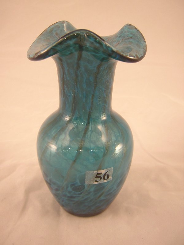 Frank Workman sample: This light blue 6.5" tall vas: Frank Workman sample: This light blue 6.5" tall vase created by glass artisan Frank workman features a cloudy white decoration and a spiral effect of narrow sparkling metallic hue. This vase is emboss
