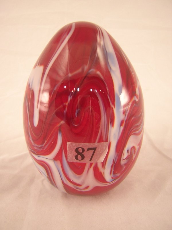 Robert Barber Egg: This 4.75" tall Barber egg is re: Robert Barber Egg: This 4.75" tall Barber egg is red with blue and white swirled colors. This egg has the Fenton oval logo and 1976.