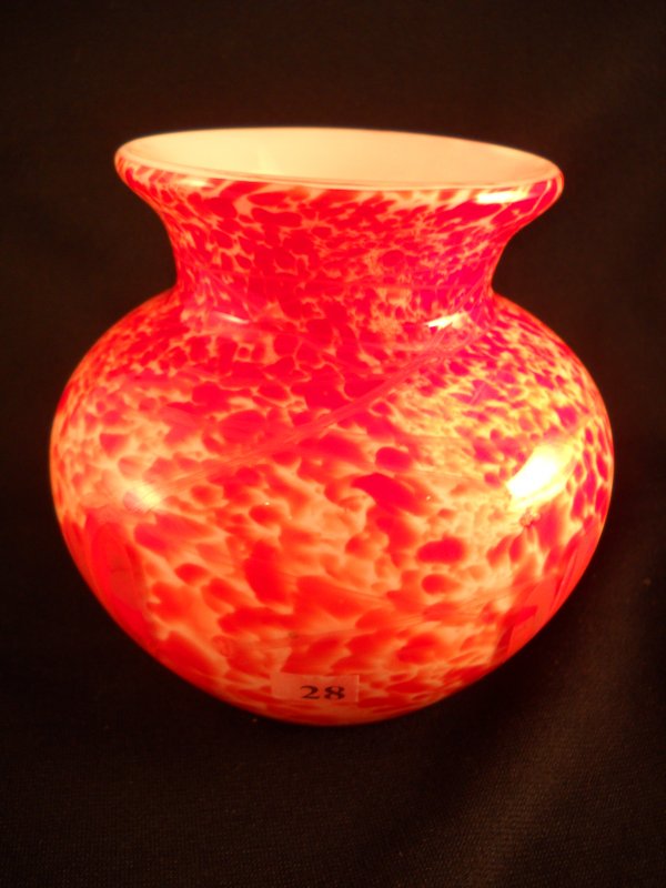 Frank Workman vase: Using Milk Glass and orange fri: Frank Workman vase: Using Milk Glass and orange frit, glass artisan Frank Workman created this dazzling 5.25" tall vase, which has an applied feather decoration and is cased with pure crystal. The vas