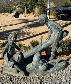 Life Size Bronze boy and girl on a log
