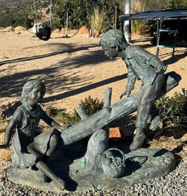 Life Size Bronze boy and girl on a log