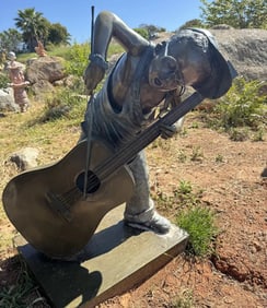 Life Size Bronze Boy Playing Instrument by Jim Davidson