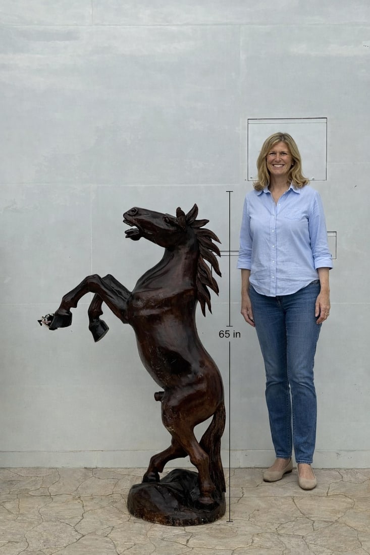 Monumental Hand-Carved Wooden Horse Sculpture: Size: 65 in H x 40 in x 20 in This is a striking hand-carved wooden sculpture of a rearing horse, captured in a powerful and dramatic pose. The horse stands on its hind legs, with its front legs