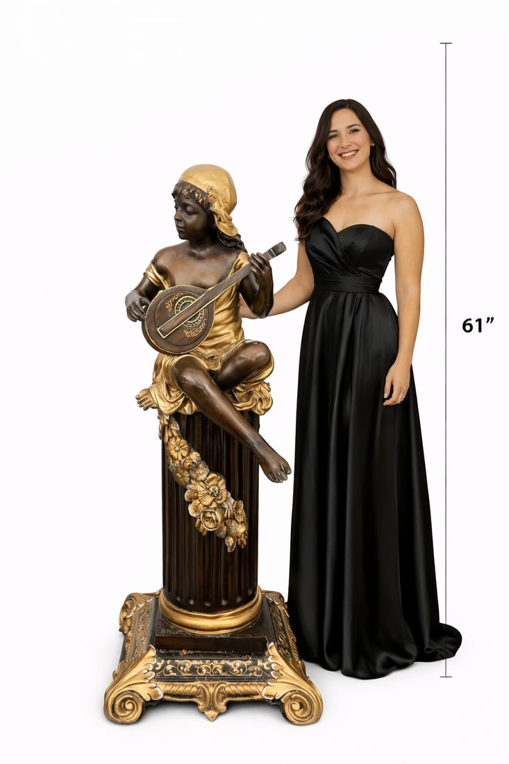 Life size Bronze Cherub Neoclassical Figure on Pedestal: This elegant sculptural piece depicts a classical cherub figure seated atop a fluted column, captured in a moment of quiet musical expression as the figure plays a flute. The cherub’s relaxed