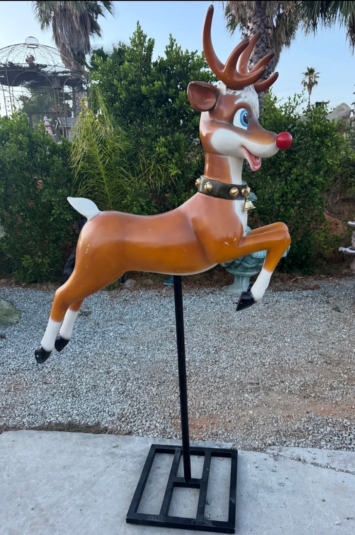 Rudolph the Red-Nosed Reindeer Fiberglass Lawn Statue: size: 76” x 45” Large fiberglass reindeer statue is modeled after Rudolph the Red-Nosed Reindeer. It has a brown body with white accents, a bright red nose, and blue eyes. The figure is mo