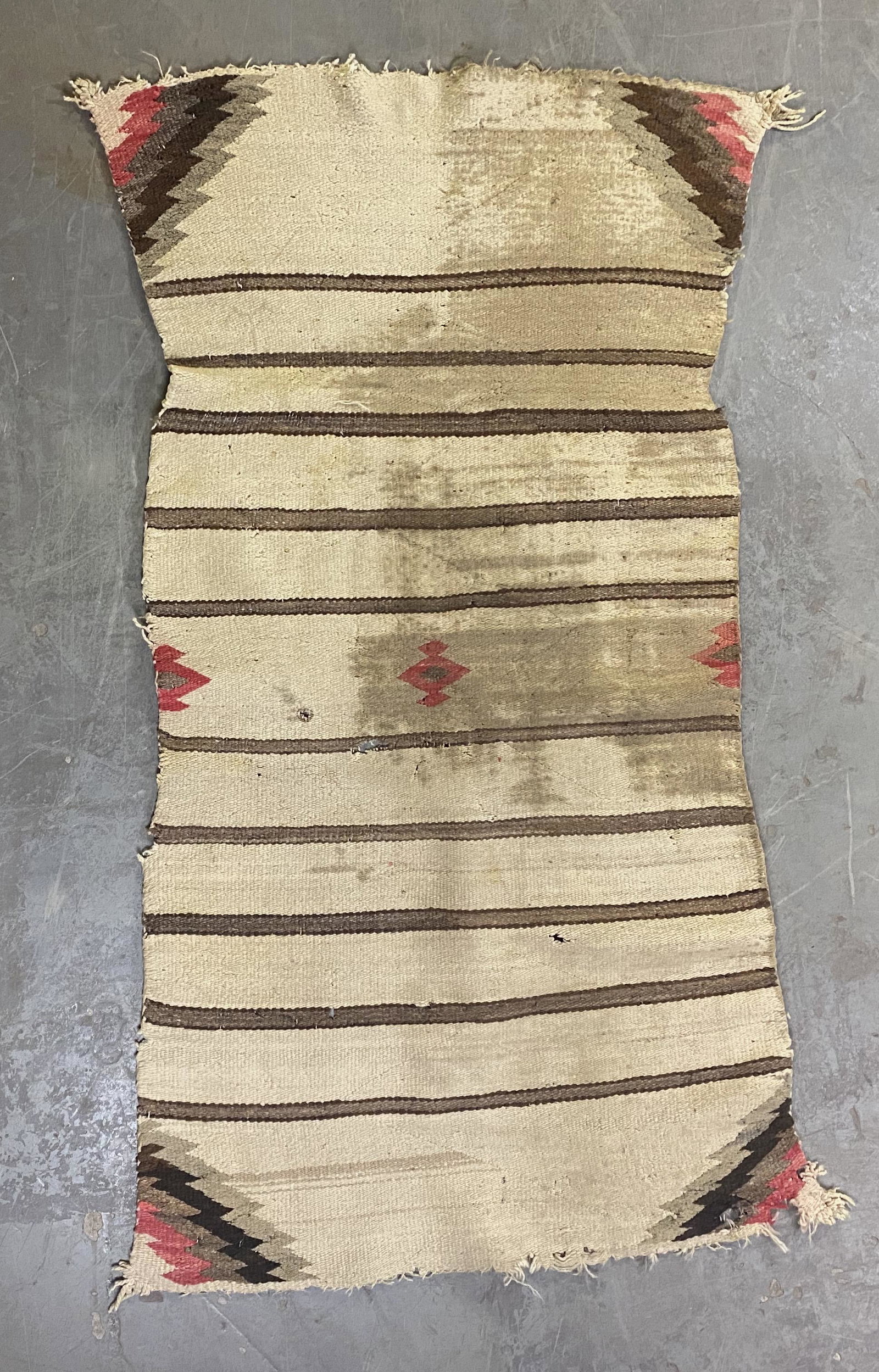Antique Navajo saddle blanket: Antique Navajo saddle blanket. Measuring 30" X 55". Significant wear, staining and edge-fraying attributable and use over decades.