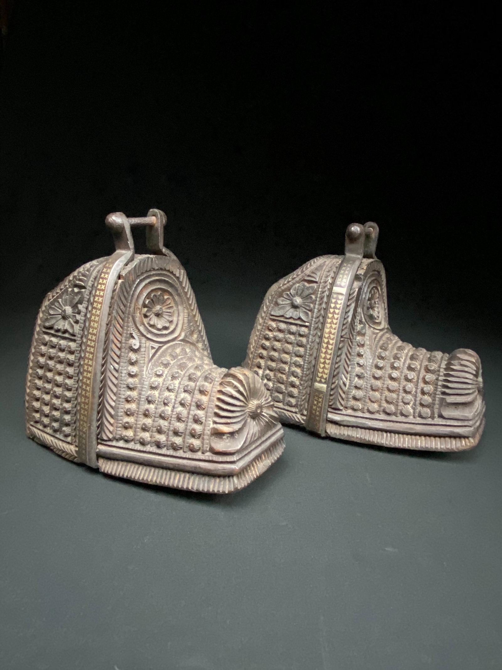 Pair of Antique Spanish Colonial Stirrups: Two hand carved wood, Spanish colonial stirrups with inlaid cast iron mounts.