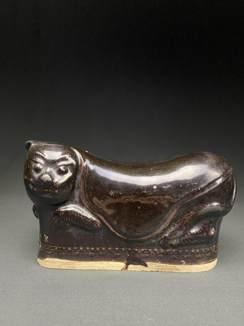 Antique Chinese Hot Water Pillow: A hollow, glazed ceramic headrest with a hole on top for introducing warm liquid.
