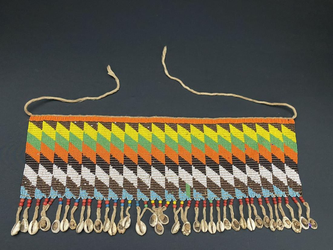 A Vintage African Modesty Belt: A Beaded Cache Sexe, enhanced with cowrie shells. Traditionally worn by the Kirdi women of Cameroon, such belts were outlawed in recent times in favor of Western dress.