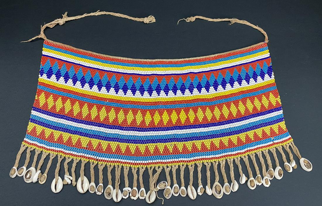 A Vintage African Modesty Belt: A beaded Cache Sexe, enhanced with cowrie shells. Traditionally worn by the Kirdi women of Cameroon, such belts were recently outlawed in favor of Western dress.