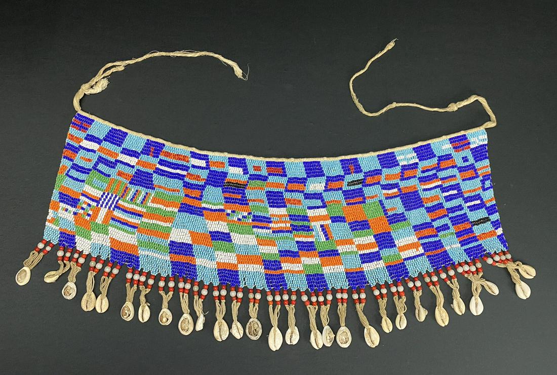 A Vintage African Modesty Belt: A beaded Cache Sexe, enhanced with cowrie shells. Traditionally worn by the Kirdi women of Cameroon, such belts were recently outlawed in favor of Western dress.