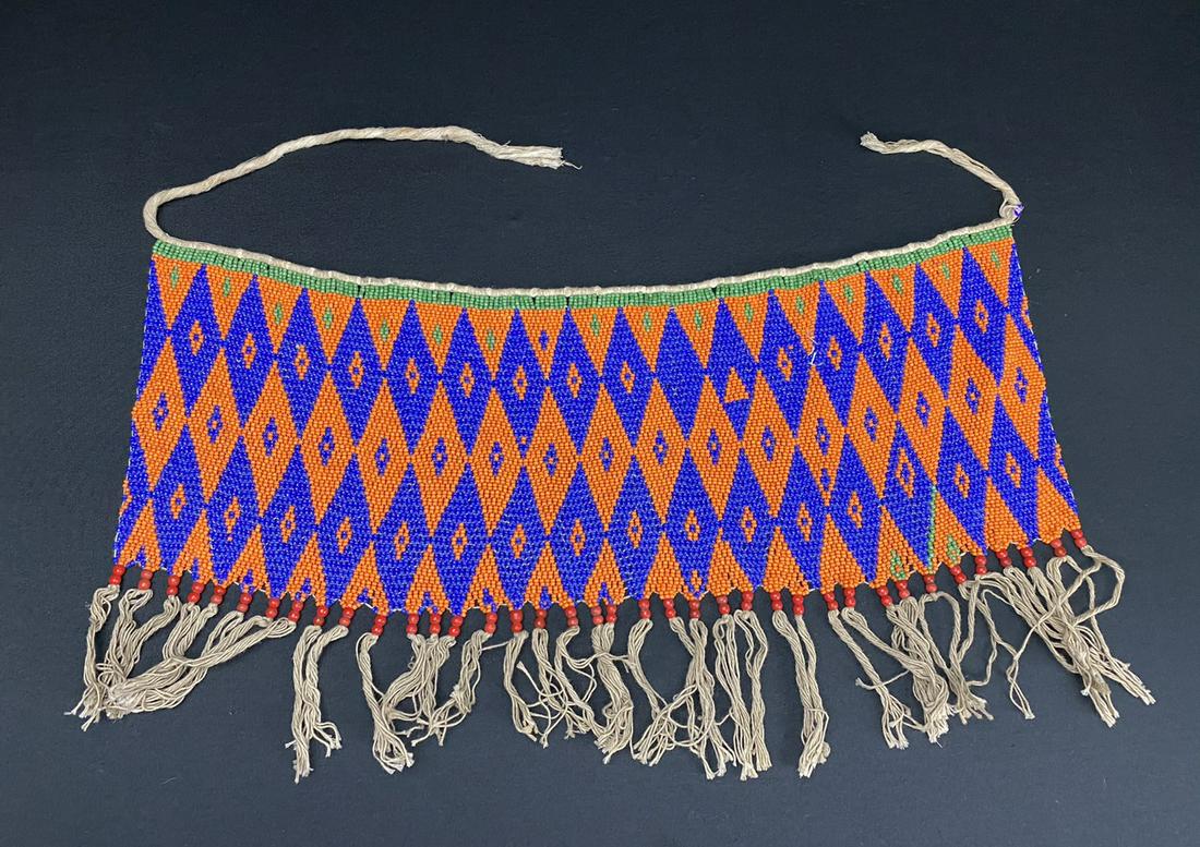 A Vintage African Modesty Belt: A beaded Cache Sexe, enhanced with Cowrie shells. Traditionally worn by the Kirdi women of Cameroon, such belts were outlawed in recent times in favor of Western dress.
