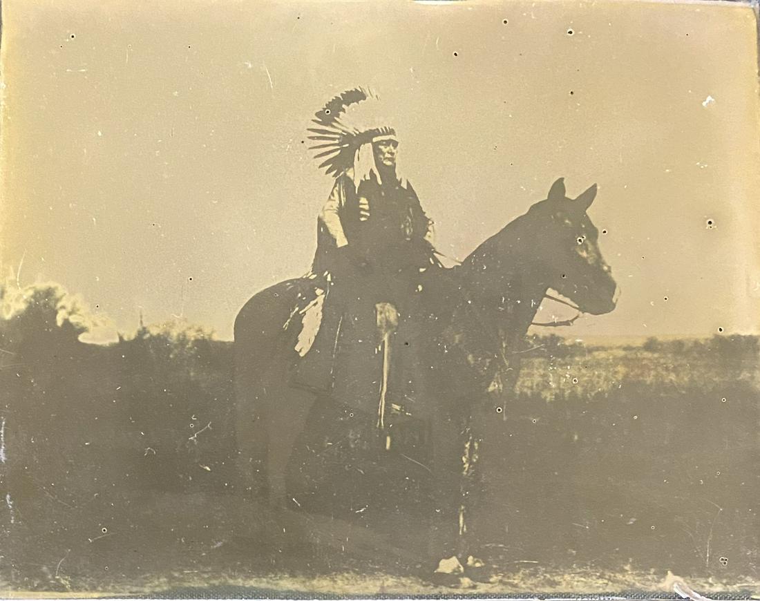 Antique photo on glass of Native American Chief on: Antique photo on glass of Native American chief on horseback. In good estate condition for age. Small chips, grime, debris and tiny bubble-shaped losses to image. Edges are rough, and hand-cut. Approx