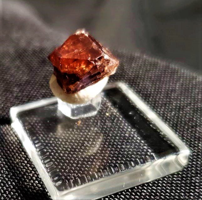 Zircon Crystal: This a Collectors piece of Zircon. Comes in protective gem case. Beautiful, gemmy, Red Zircon Crystal. Zircon is one of the oldest minerals on the planet with some being carbon dated at 4.4 billion ye