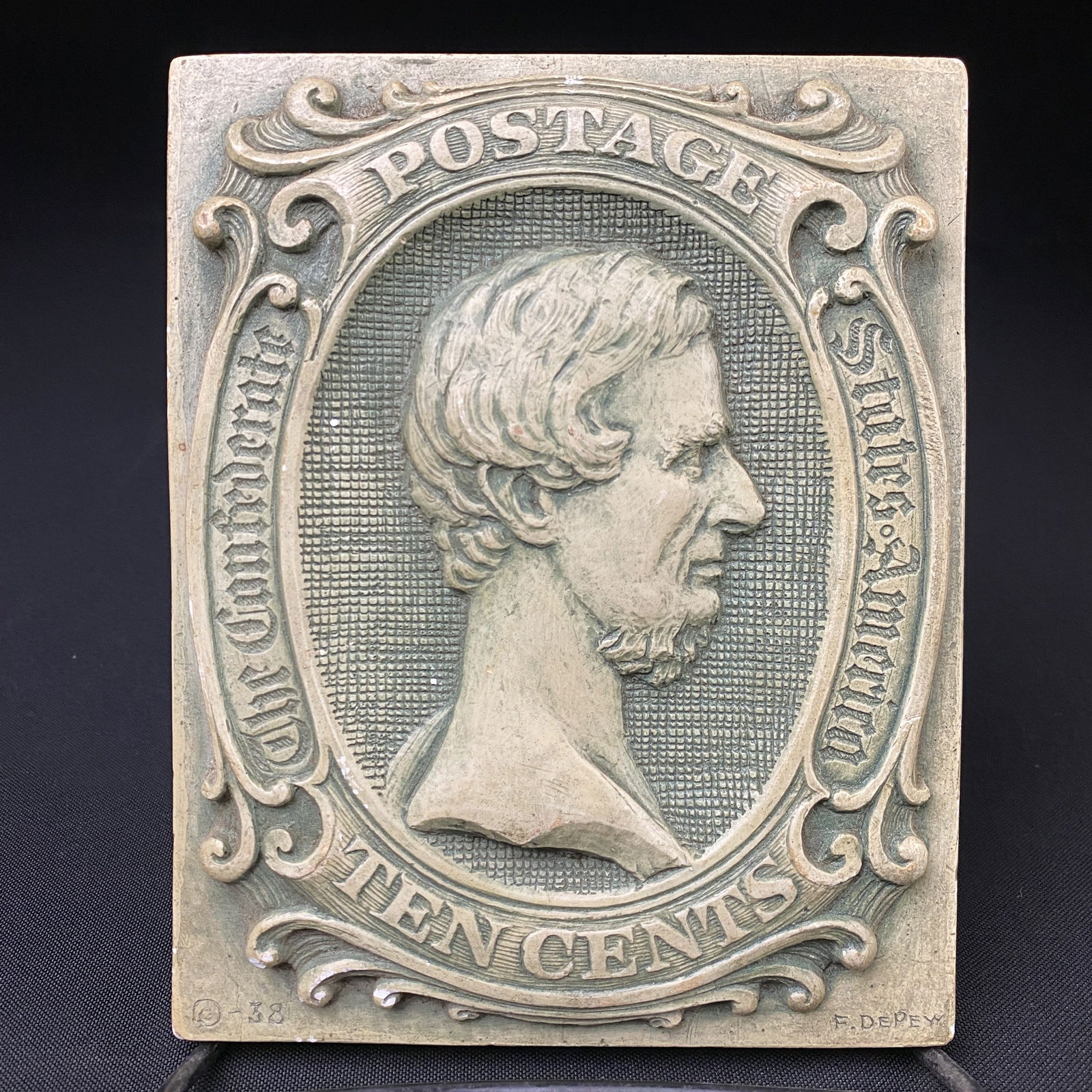 Depew Studios Famous 10 Cent Confederate Stamp in a Plaster Relief: Depew Studios Famous 10 Cent Confederate Stamp in a Plaster Relief. There is a explanatory paper on the back describing the history of the imagery of Lincoln.