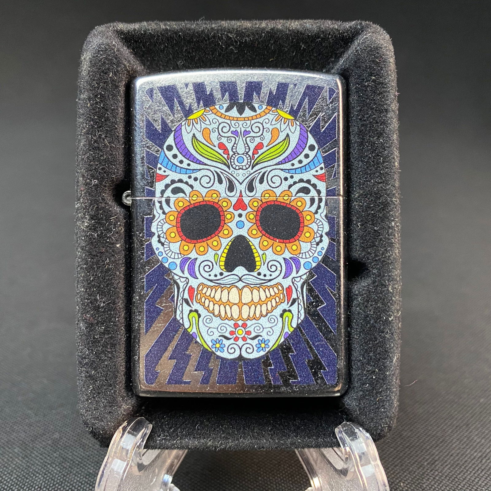 Sugar Skull Zippo Lighter: Sugar Skull Zippo lighter, with original lighter seal on back. Still in box insert, but no box. Never been used. Condition is excellent. J, 19 stamped model markings at bottom of lighter. Insert case