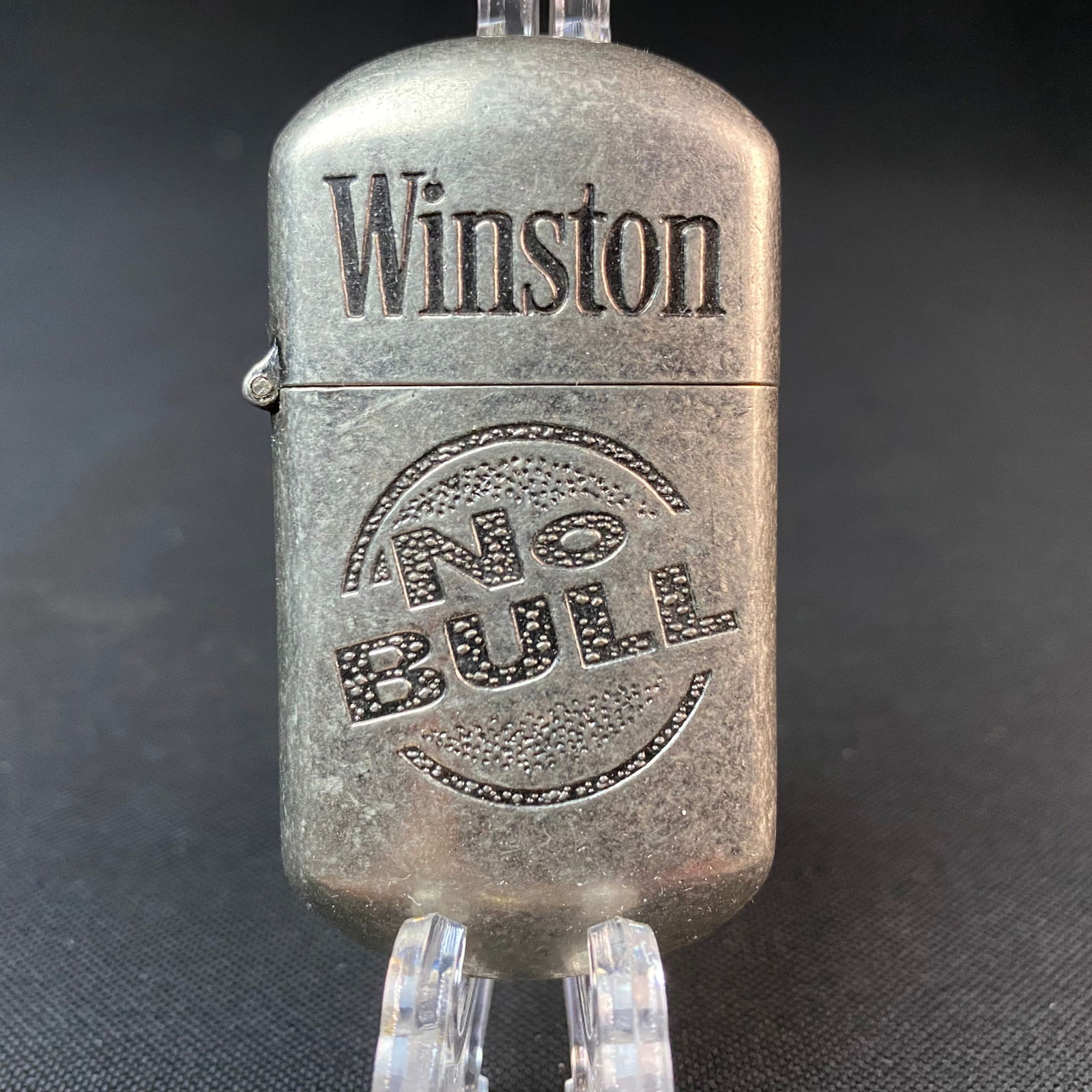 No Bull Lighter by Winston: No Bull Lighter by Winston. Never been used. Condition is good. Made in China Sticker on bottom. Lighter measures 2 9/16 tall by 1 3/8 wide by 1/2 thick/deep.