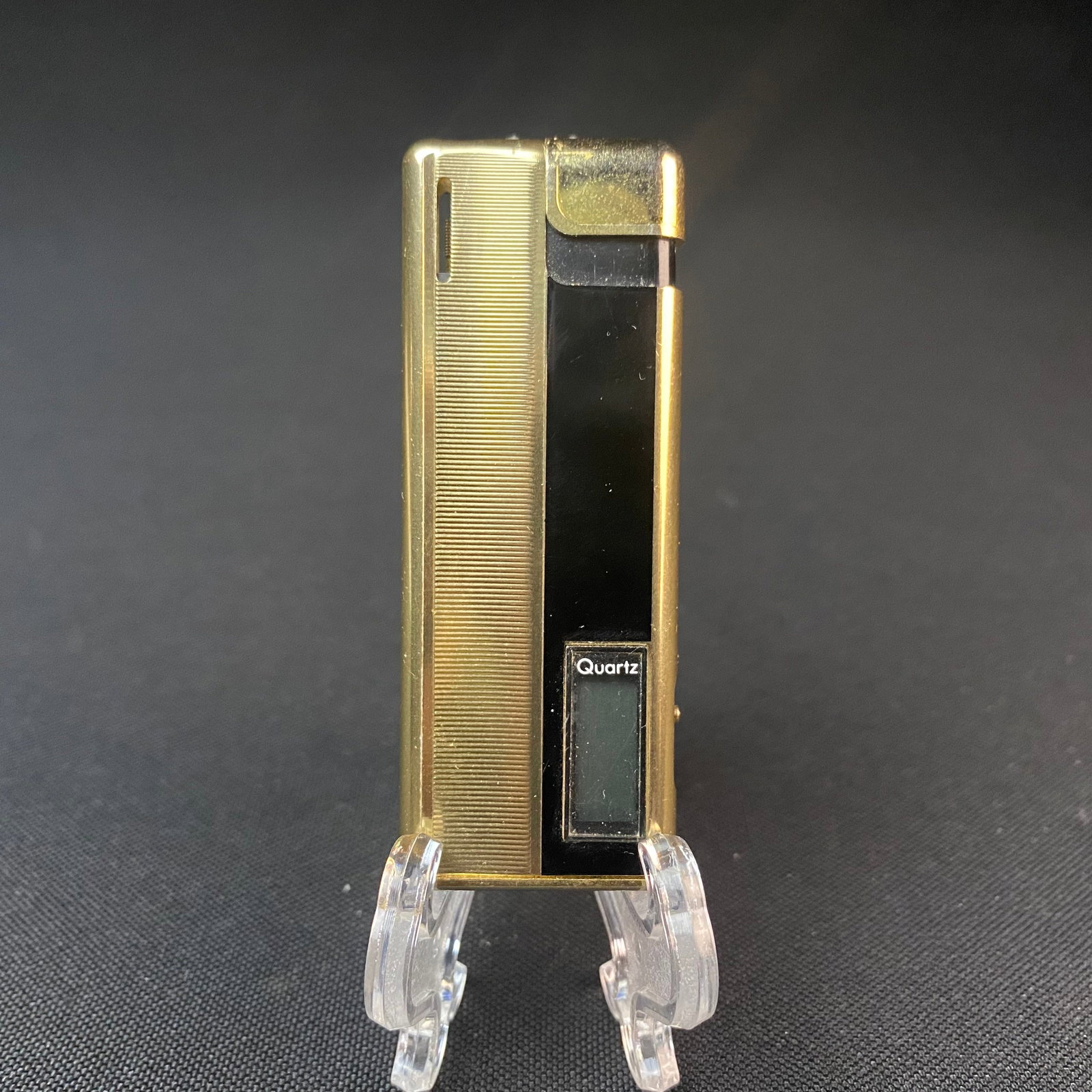 Gold and Black Lucienne Electro Quartz Butane Lighter: Gold and Black Lucienne Electro Quartz Butane Lighter. Used. Condition is Good. Marked Lucienne Japan on bottom of lighter. Lighter measures 2 7/8 tall by 3/8 wide by 5/16 thick/deep.
