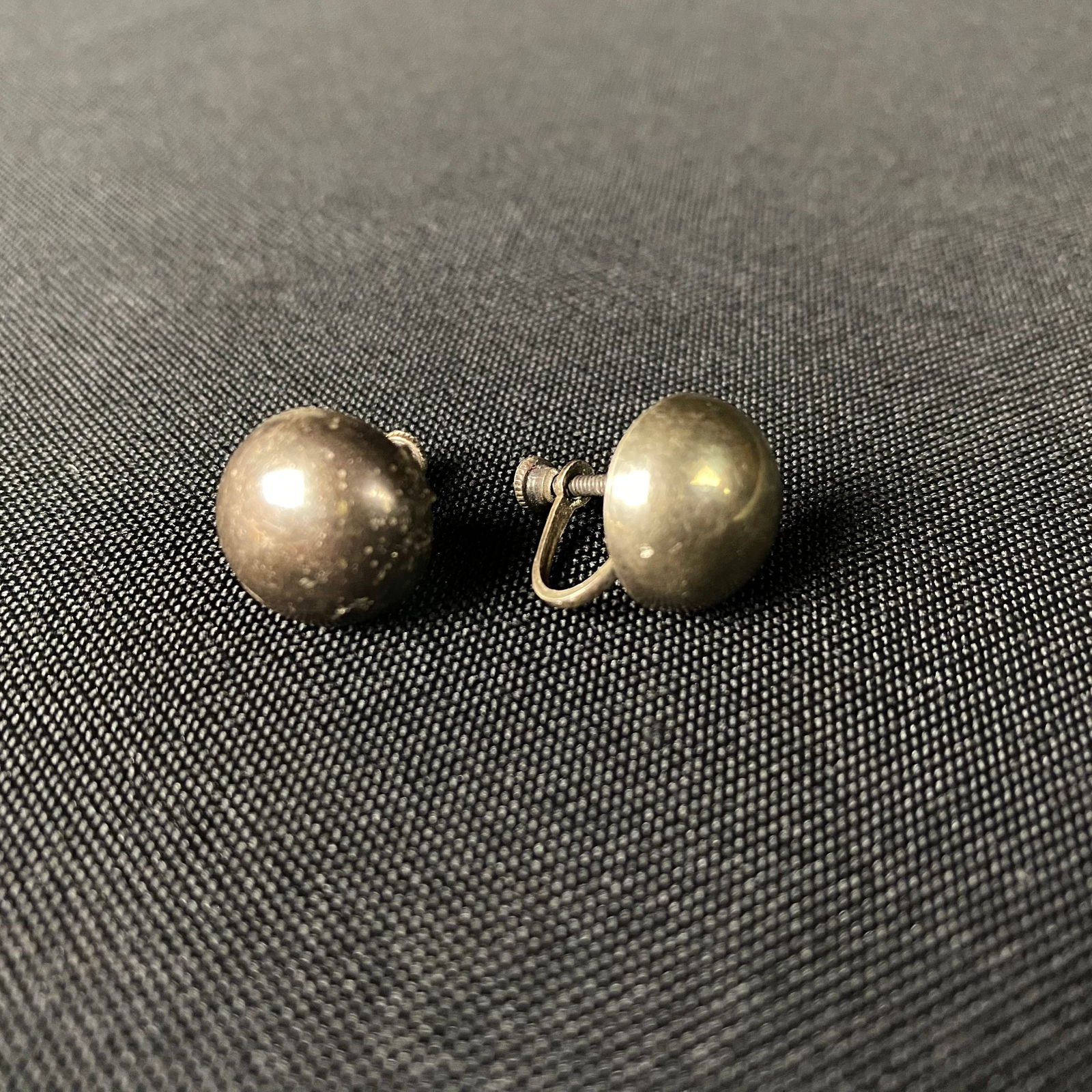 Sterling Silver Button or Concho Style Screw Back Earrings: Sterling Silver Button Style Screw Back Earrings. Condition is great with a mild patina and minor surface wear and grime. They are stamped Sterling on the back of the screw clamp. They measure 11/16 t
