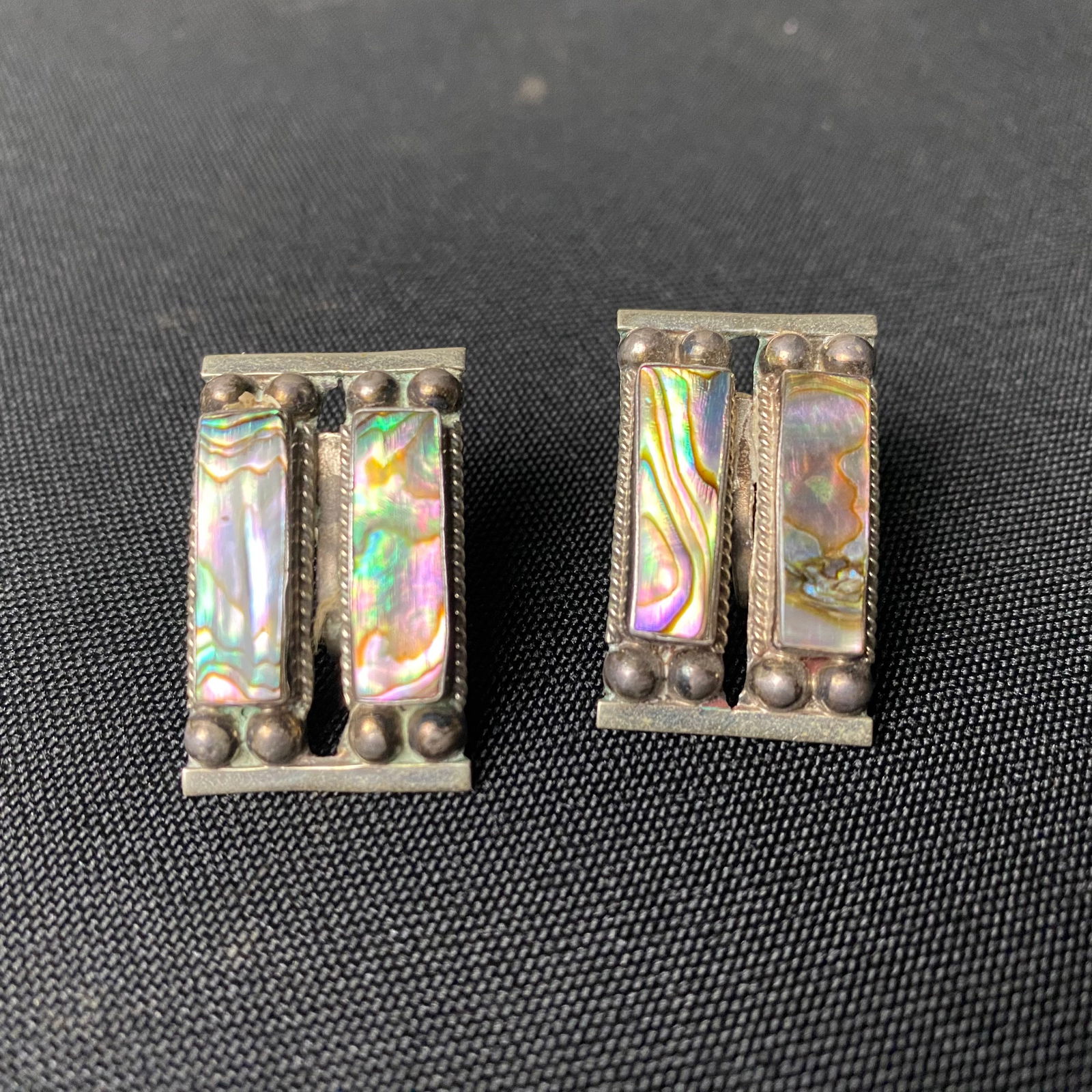 Sterling Silver and Abalone Curved Rectangular Screw Back Earrings: Sterling Silver and Abalone Curved Rectangular Screw Back Earrings. They are in excellent condition with some minor surface wear and grime. They are split into two sections, with a slit down the cente
