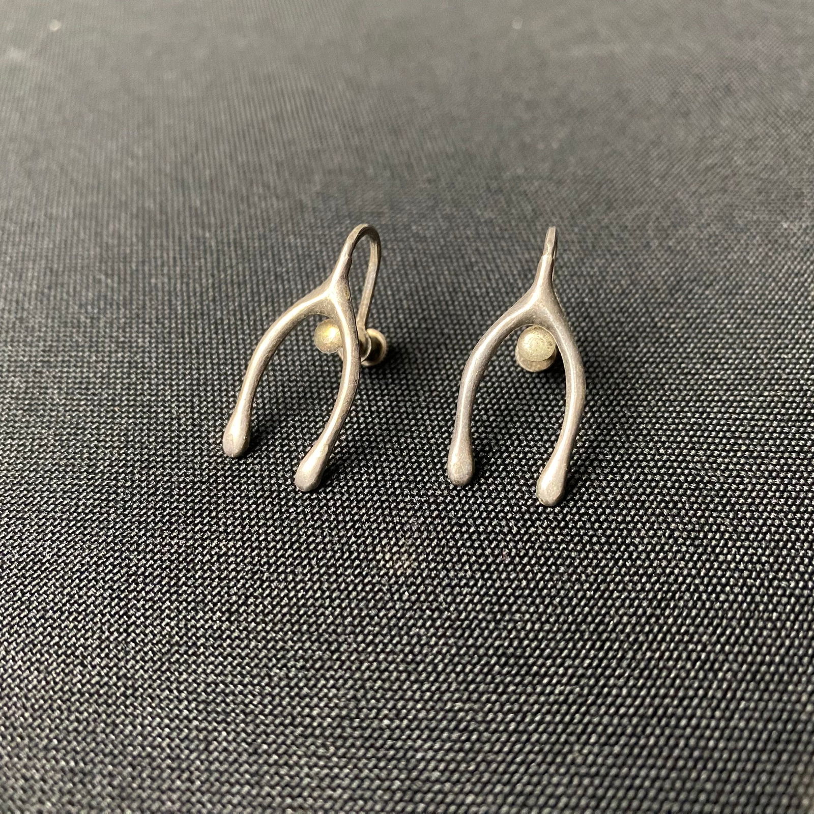 Sterling Silver Wishbone Screw Back Earrings: Sterling Silver Wishbone Screw Back Earrings. They are in excellent condition with minor surface wear and grime. They are stamped Sterling on the back of the screw clamp. They measure 1 1/16 tall by 1
