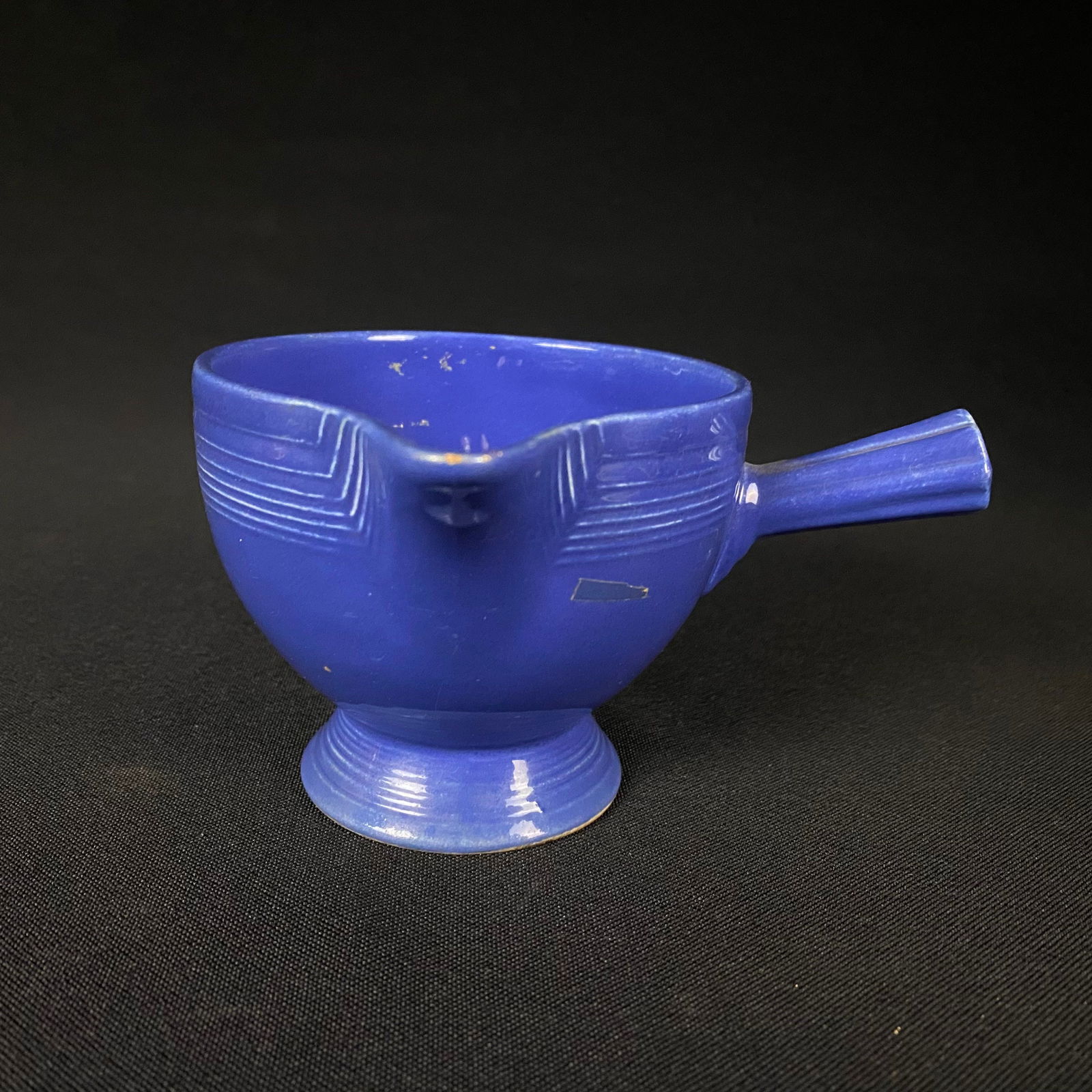 Vintage Homer Laughlin Fiesta Blue Demitasse Stick-Handle Creamer Cup: Vintage Homer Laughlin Fiesta Blue Demitasse Stick-Handle Creamer Cup. It is in excellent condition with no chips, cracks, or breaks, and minor surface wear including scratches, minor dulling of the