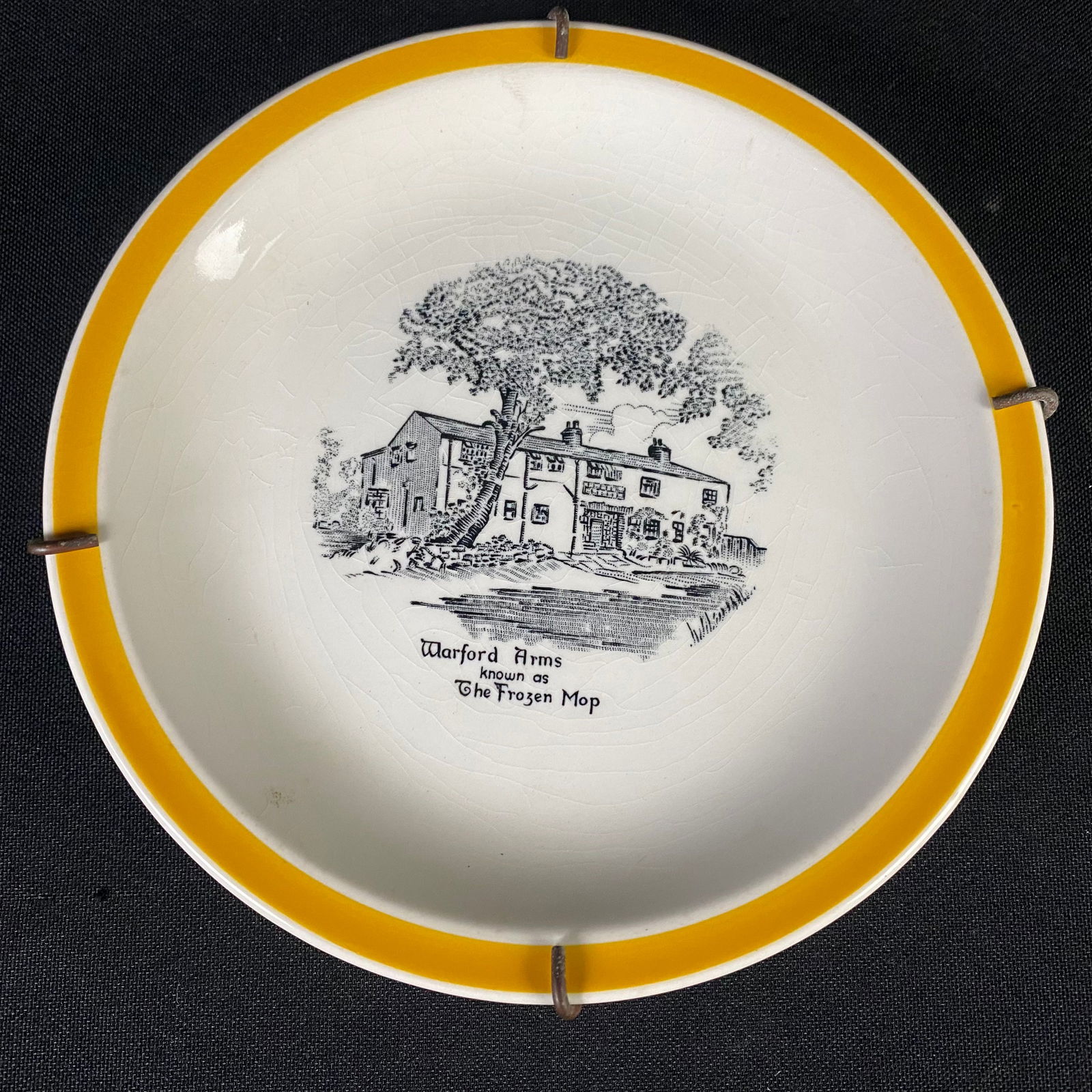 Mid Century Solian Ware Plate by Simpson Potteries of Cobbridge, England with Wall Mount: Mid Century Rogue Plate by Simpsons Potteries of Cobridge, England with Wall Mount. It is in excellent condition with minimal surface wear and grime. Comes with the wall mount. It has Rogue.. Simpsons