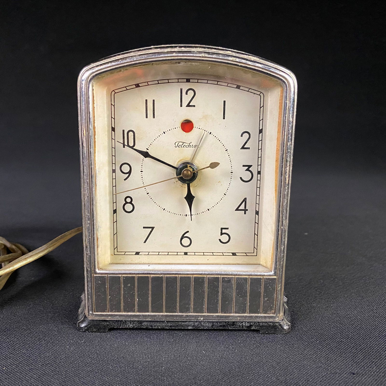 Telechrom model 711 alarm clock: Telechrom model 711 alarm clock. It is in fair to good condition with moderate surface wear and grime including scratches to the chrome finish and some spots of mild oxidation. The light works, but th