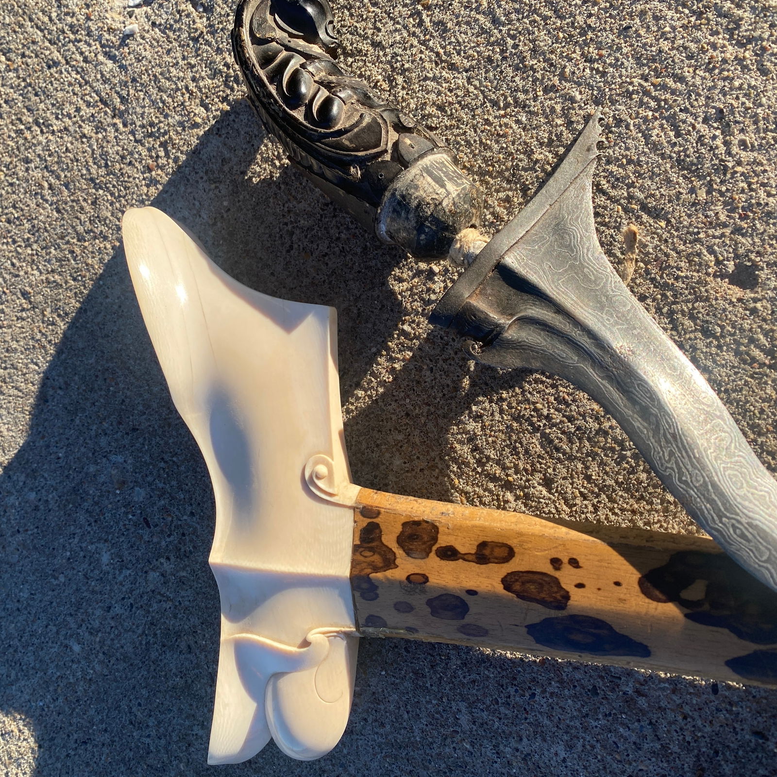 Antique Kriss with Horn and Gold Hilt and Ivory and Wood Sheath: Antique Kriss with Horn and Gold Hilt and Ivory and Wood Sheath. The blade measure 13" long and is 3" wide. The overall length is approximately 26" long. The horn hilt used to be adorned with gold. Al