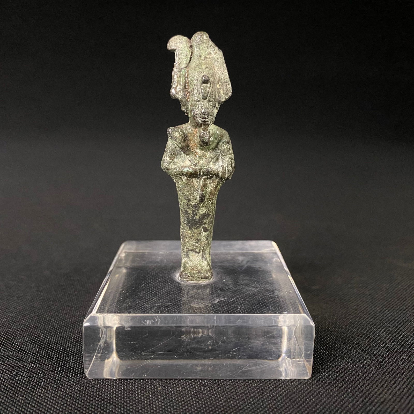 Ancient Egyptian Bronze Statue of Osiris: Ancient Egyptian Bronze Statue of Osiris. It is in good condition with a small crack visible in the headdress and some heavy oxidation and patina. Statue is mounted on a clear acrylic platform with be